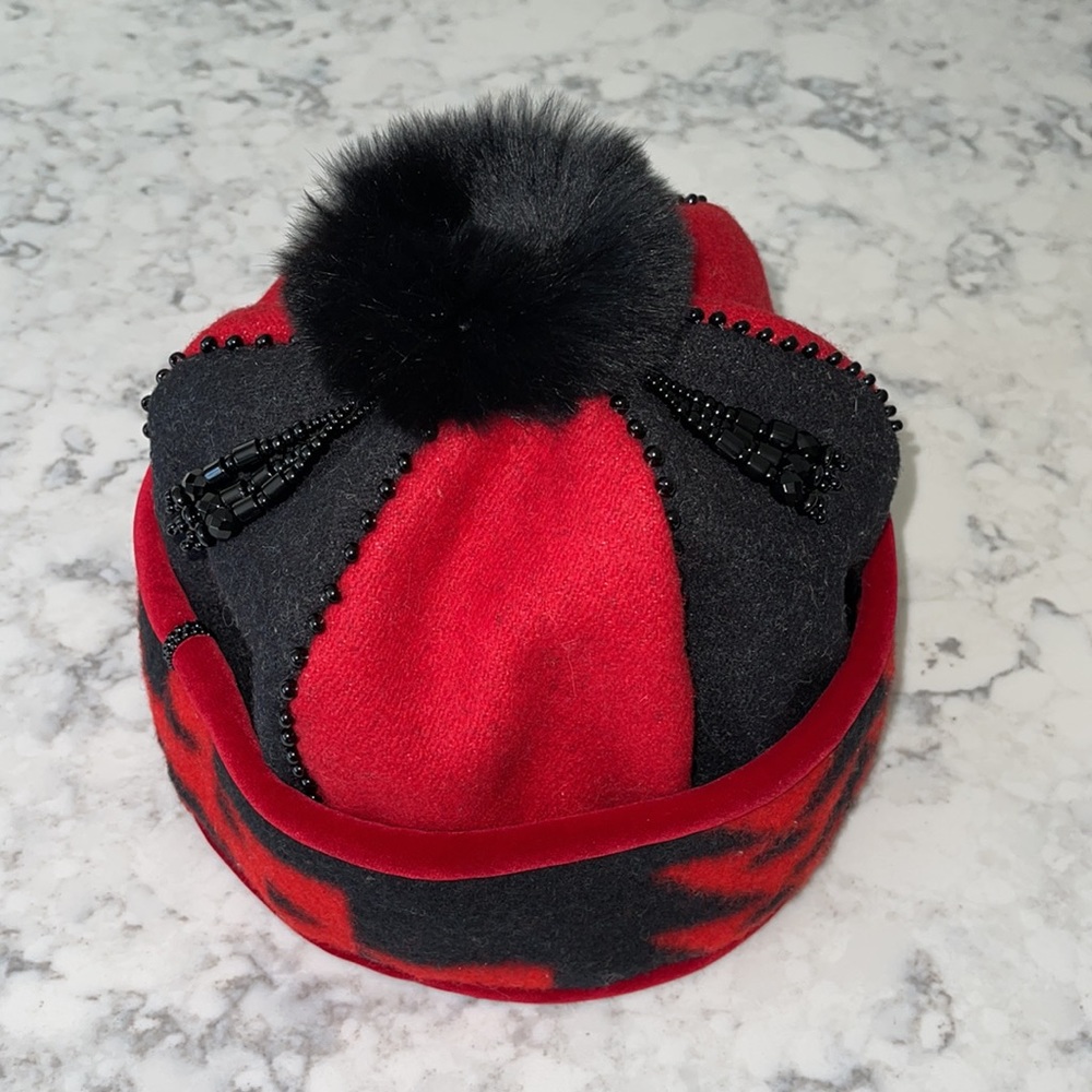 Ladies hat with fur lined interior trim and pom-pom with beading